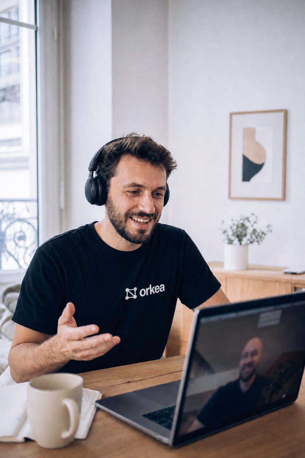 A Centralys developer on a video call with a client, wearing an Orkea t-shirt